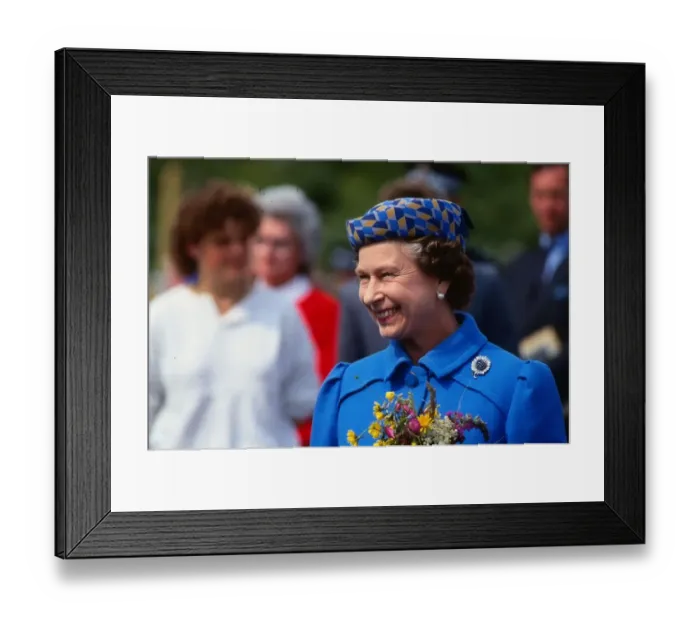 Framed Print : Queen Elizabeth II August 1986 holding flowers wearing a blue coat yellow blue hat on a Framed Print : Queen Elizabeth II August 1986 holding flowers wearing a blue coat yellow blue hat on a
