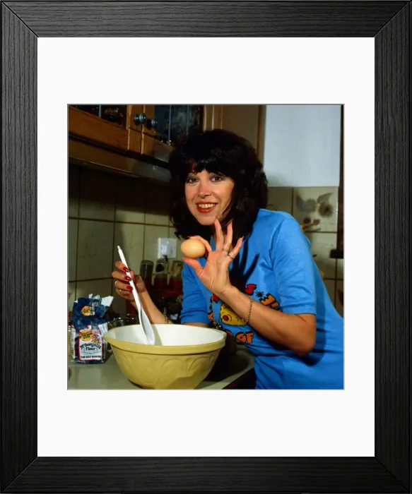 Framed Print : Sally James in kitchen making cake September 1981