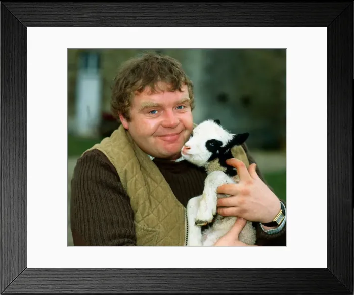 Framed Print : Geoffrey Hughes holding baby goat April 1982 Framed Print : Geoffrey Hughes holding baby goat April 1982