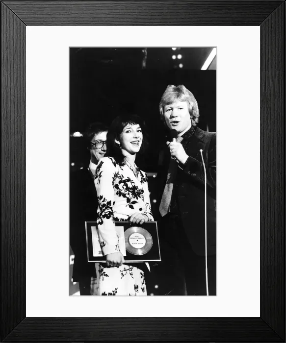 Framed Print : Pop singer Kate Bushholds her award as she stands with Radio 1 Disc Jockey David Kid Framed Print : Pop singer Kate Bushholds her award as she stands with Radio 1 Disc Jockey David Kid