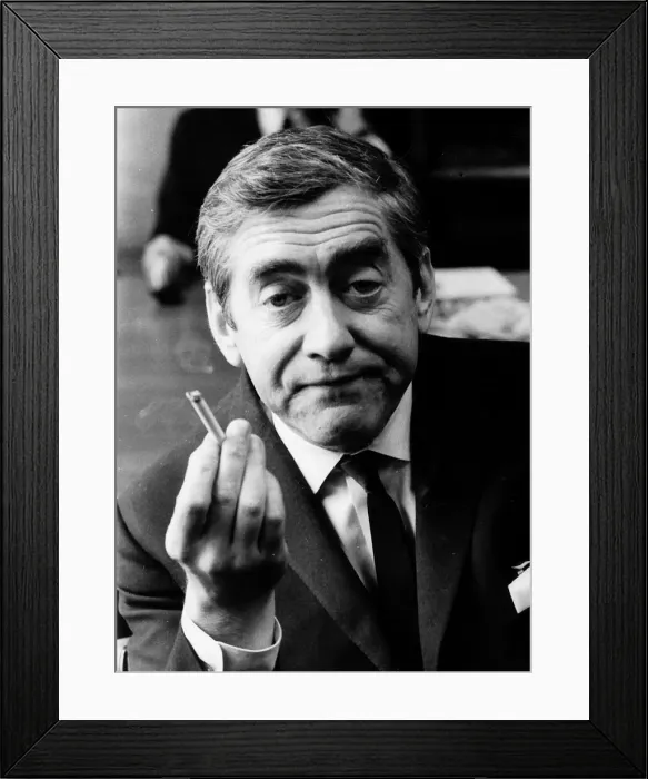 Framed Print : Tony Hancock holding up a lit cigarette August 1966