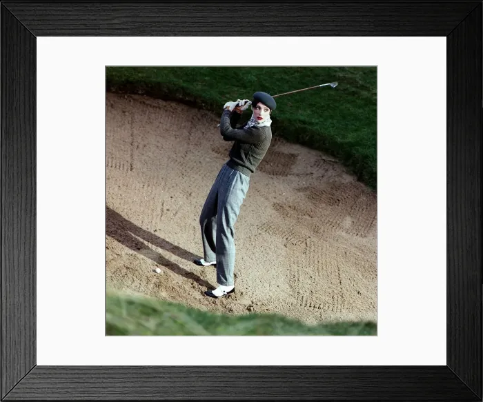 Framed Print : Golf Fashion female golfer in bunker grey trousers