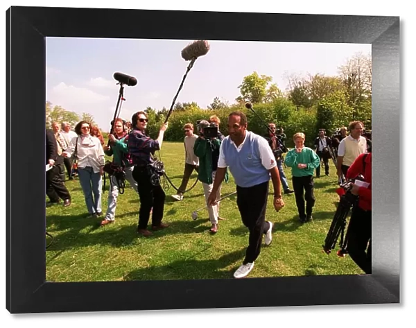 OJ Simpson is surrounded by the press as he plays golf on his English visit