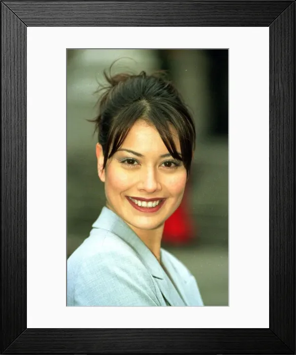 Framed Print : Models Melanie Sykes wears a lycra grey suit from Marks