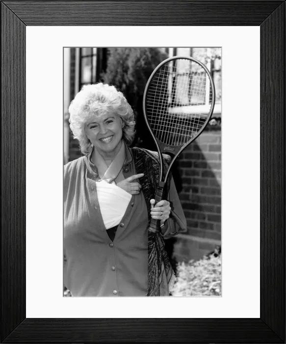 Framed Print : Gloria Hunniford TV Presenter holding the tennis racket she was useing when she broke her Framed Print : Gloria Hunniford TV Presenter holding the tennis racket she was useing when she broke her