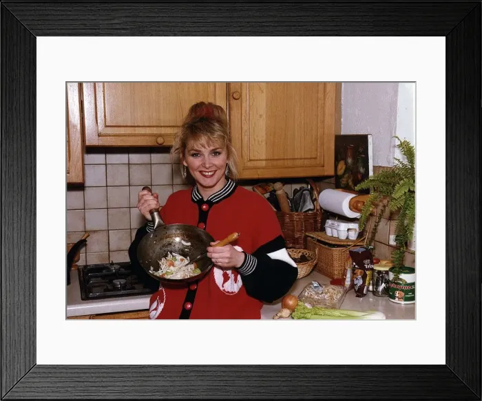 Framed Print : Cheryl Baker former Bucks Fizz singer and TV presenter cooking a stir fry in her kitchen Framed Print : Cheryl Baker former Bucks Fizz singer and TV presenter cooking a stir fry in her kitchen