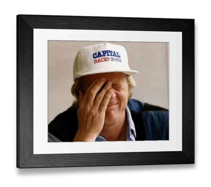 Framed Print : Chris Tarrant radio and TV presenter wearing one of his two hats during interview