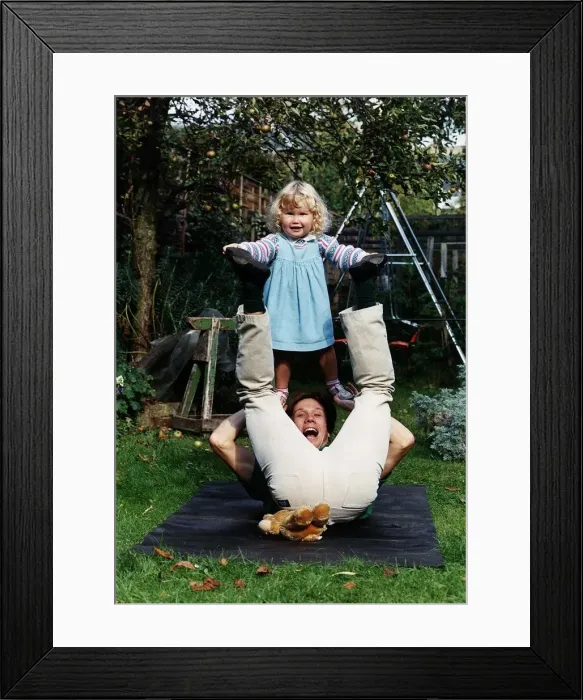 Framed Print : Peter Duncan TV presenter of Blue Peter playing in the garden with his daughter Framed Print : Peter Duncan TV presenter of Blue Peter playing in the garden with his daughter