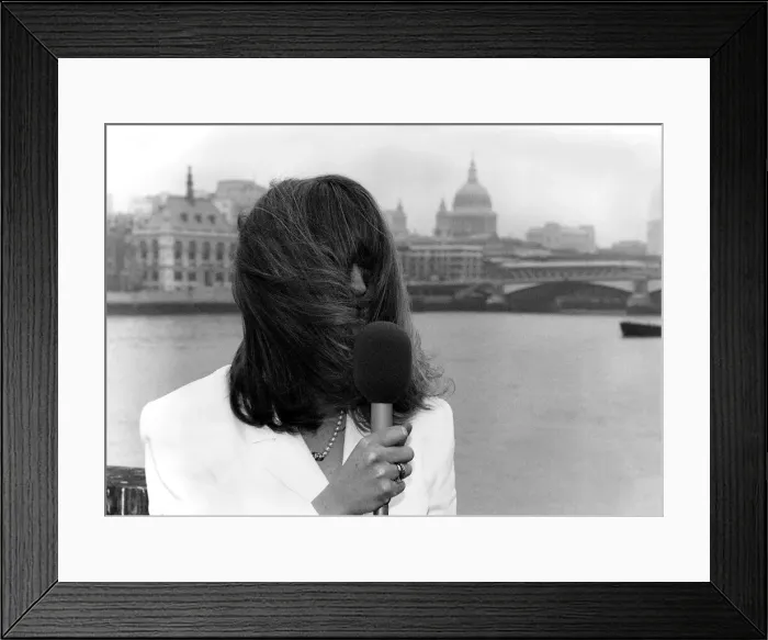 Framed Print : Caron Keating TV Presenter holding microphone hair blowing over her face