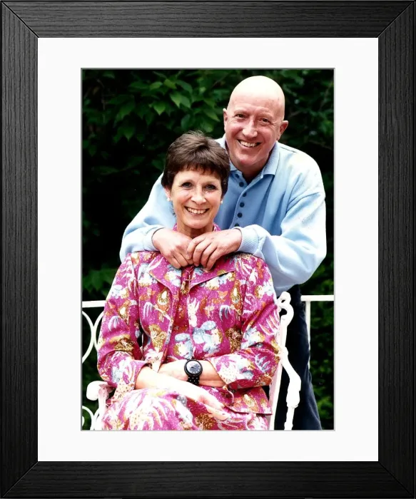 Framed Print : Roy Castle TV Presenter standing behind wife in garden