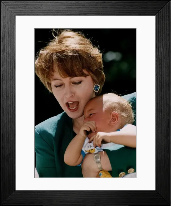 Framed Print : Anne Diamond TV Presenter holding baby Framed Print : Anne Diamond TV Presenter holding baby