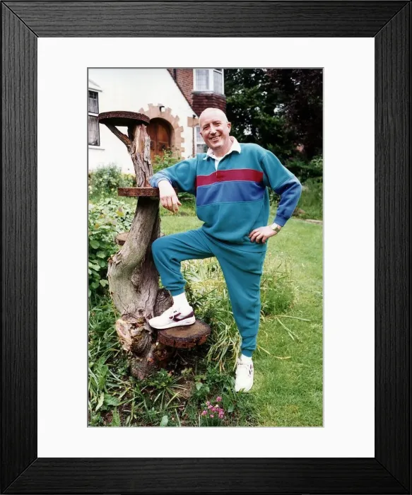 Framed Print : Roy Castle TV Presenter in garden with foot on tree Framed Print : Roy Castle TV Presenter in garden with foot on tree