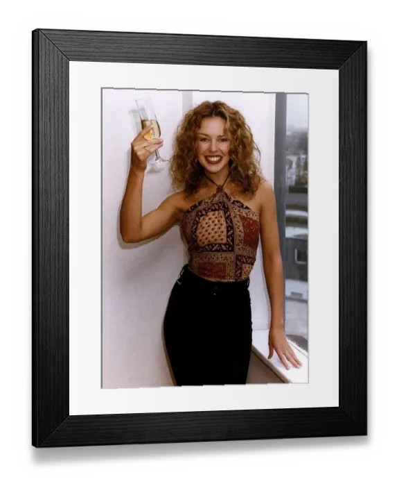 Framed Print : Kylie Minogue Actress Singer Celebrates With A Glass Of Champagne After Signing A New Framed Print : Kylie Minogue Actress Singer Celebrates With A Glass Of Champagne After Signing A New
