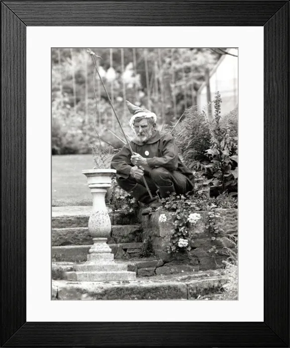 Framed Print : Walter Sherratt, aged 67, is posing as a garden gnome in his garden at Biddulph