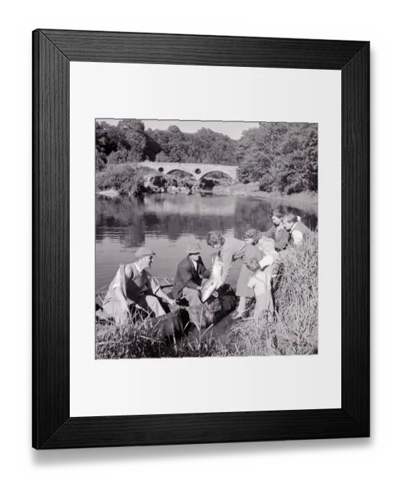Framed Print : Coracle Fisherman proudly shows his 20lb catch to his wife