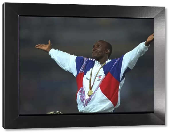 Linford Christie of Great Britain acknowledges the cheers of the crowd during the medal