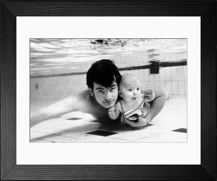 Framed Print : Swimming Underwater baby Tracey four months old with father Steve Appleby