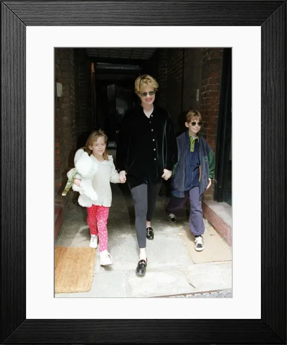 Framed Print : Melanie Griffith Actress leaving her flat in mayfair with children Dakota and Alexander