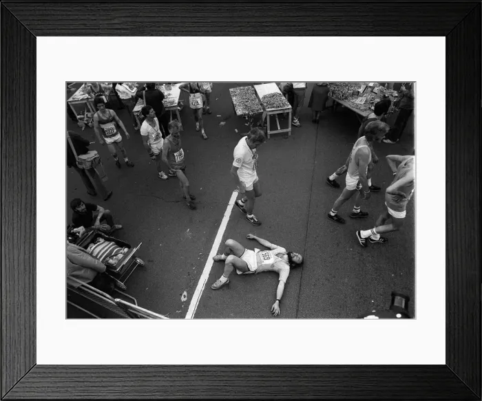 Framed Print : Marathon runners at the end of the London Marathon looking tired collecting their medals