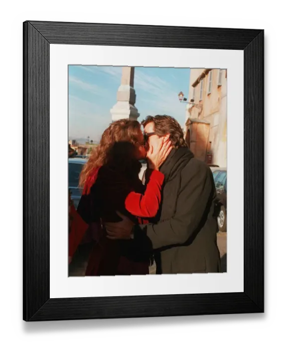 Framed Print : Pierce Brosnan and girl friend kissing Keely Shaye Smith outside Hassler hotel in Rome