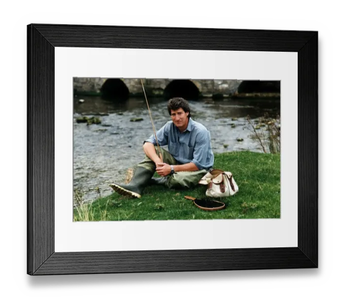 Framed Print : Jeremy Paxman tv presenter of Newsnight and journalist with his fishing gear on riverbank