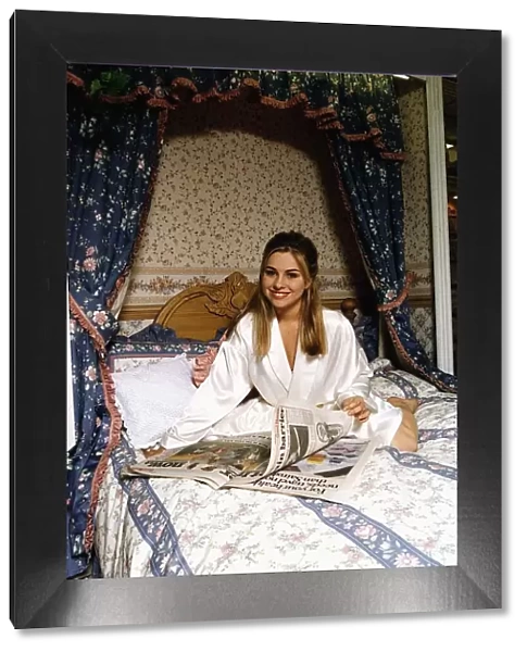 Melissa Bell Actress Laying On A Bed Reading The Newspaper