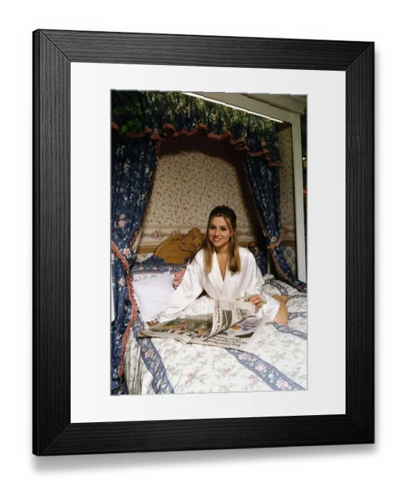 Framed Print : Melissa Bell Actress Laying On A Bed Reading The Newspaper