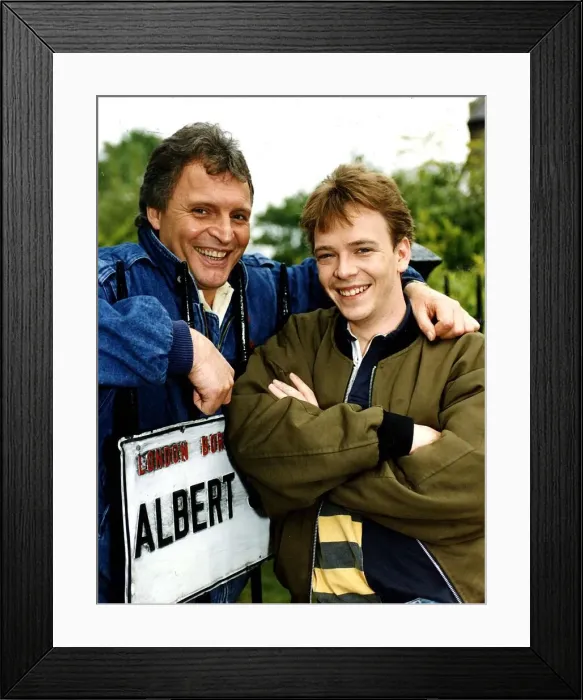 Framed Print : Adam Woodyatt who stars in Eastenders as Ian Beale, poses beside an Albert Square street