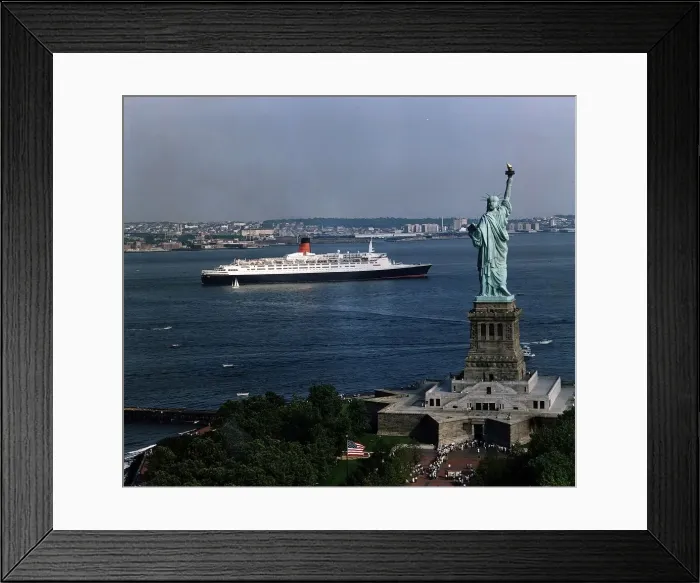 Framed Print : The QE2 Ship leaves New York Harbour past the Statue of Liberty April 1992