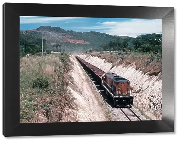 A loaded iron-ore train heads for the port of Mocamedes in South West Angola Circa