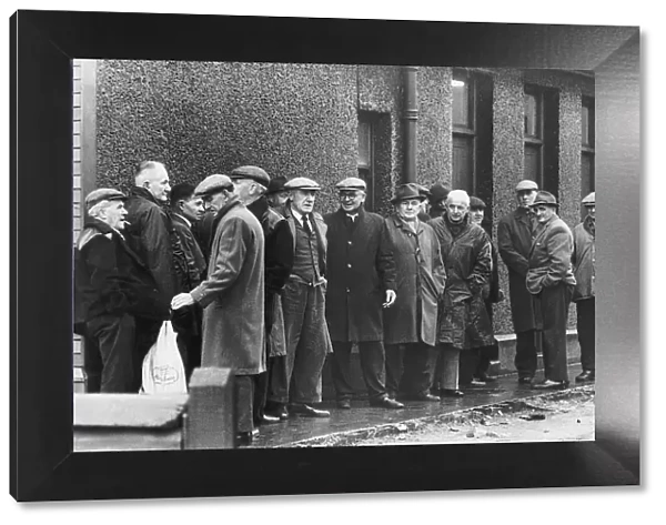 Unemployed miners pictured queuing at the dole at Rhos employment exchange after