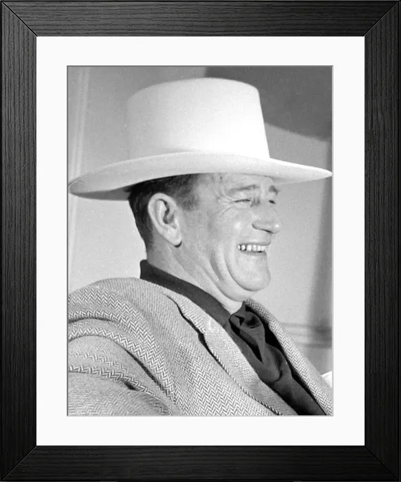 Framed Print : John Wayne, American film actor, arrives in London for the opening of his film Framed Print : John Wayne, American film actor, arrives in London for the opening of his film