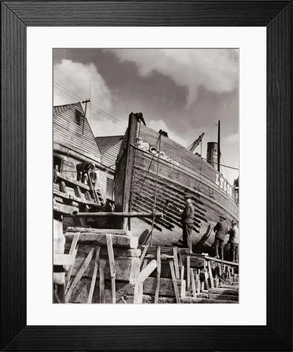Framed Print : Shipyard workers re caulking a Lowestoft herring boat on stocks in dry dock Circa Framed Print : Shipyard workers re caulking a Lowestoft herring boat on stocks in dry dock Circa