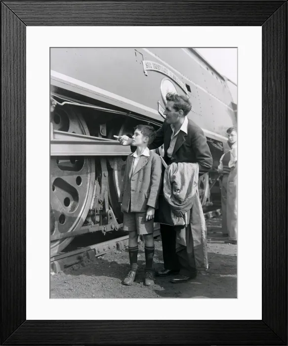 Framed Print : A father and son admire the steam locomotive during an open day at the Ashford railway Framed Print : A father and son admire the steam locomotive during an open day at the Ashford railway