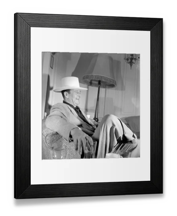 Framed Print : John Wayne, American film actor, arrives in London for the opening of his film Framed Print : John Wayne, American film actor, arrives in London for the opening of his film