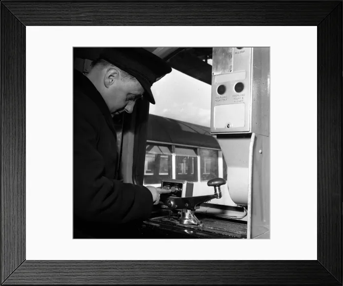Framed Print : A guard at the controls of one of London Underground