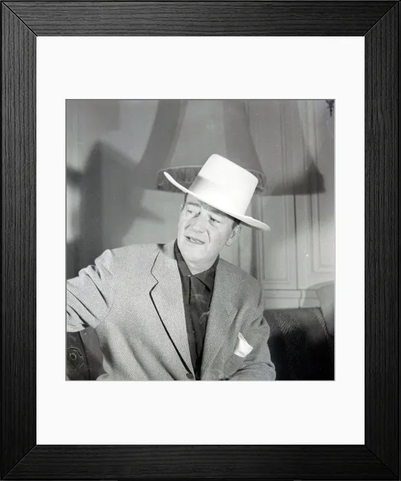 Framed Print : John Wayne, American film actor, arrives in London for the opening of his film Framed Print : John Wayne, American film actor, arrives in London for the opening of his film