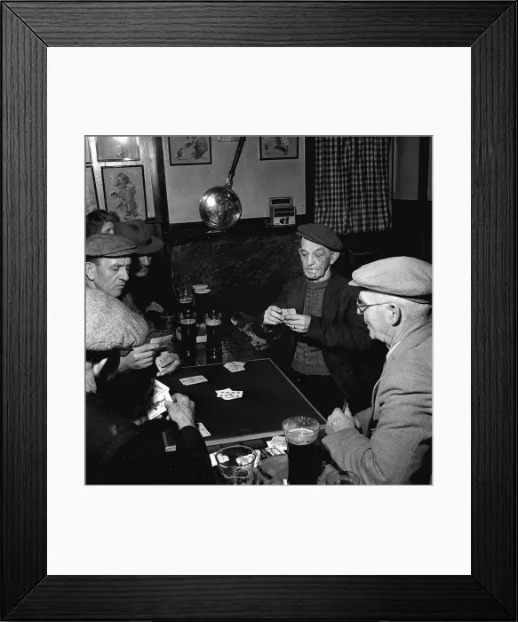 Framed Print : Fisherman around the table playing cards in a pub in St Ives in Cornwall February