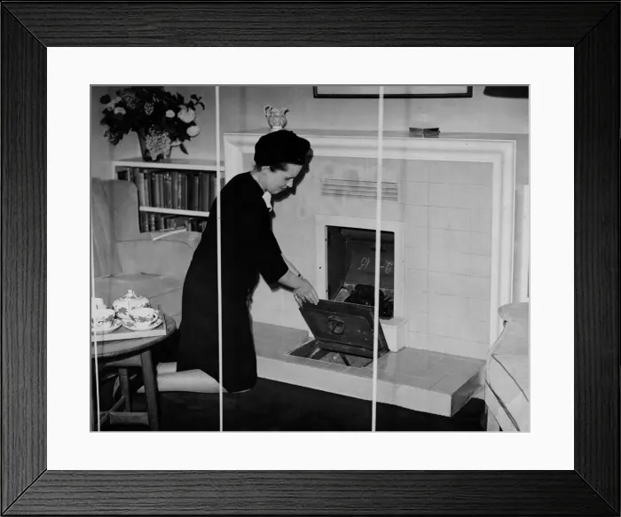 Framed Print : A woman kneels down to clean her continuous burning coal fire May 1945 Framed Print : A woman kneels down to clean her continuous burning coal fire May 1945