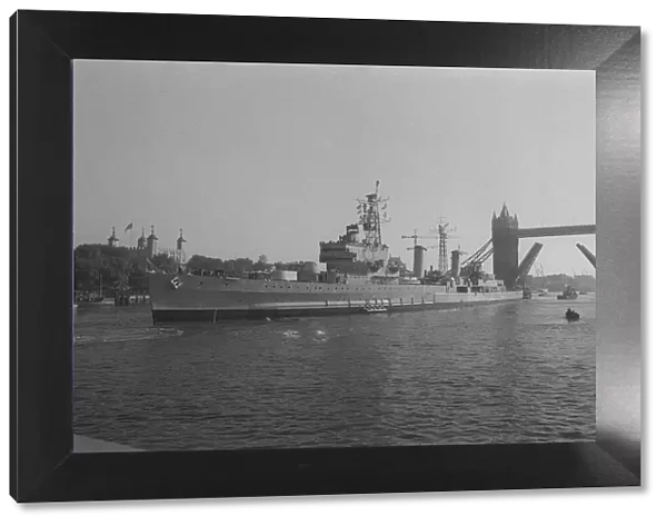 HMS Belfast sailing up the Thames 1971 passing through Tower Bridge to her mooring