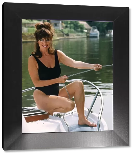 Vicki Michelle actress from Allo Allo cools off on a boat by the river during a spell of