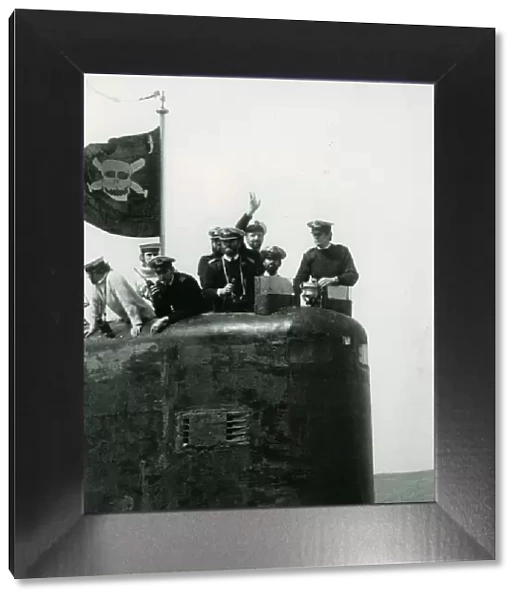 The conning tower of HMS Conqueror with the captain and crew members flying the jolly