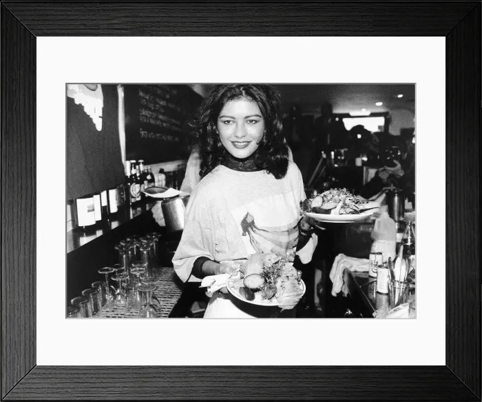Framed Print : Catherine Zeta Jones Actress plays a waitress at the Cafe Casbar in aid of a charity