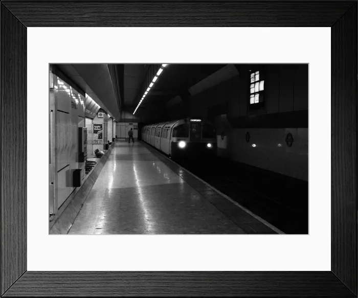 Framed Print : A train approaches the platform at Heathrow Airports terminal four tube station