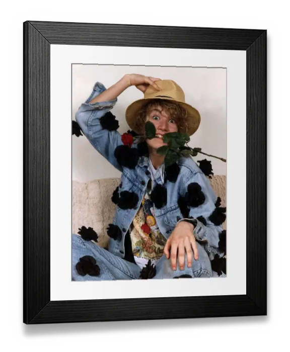 Framed Print : Emily Lloyd Actress sitting with hand on top of hat and with red rose in teeth Framed Print : Emily Lloyd Actress sitting with hand on top of hat and with red rose in teeth