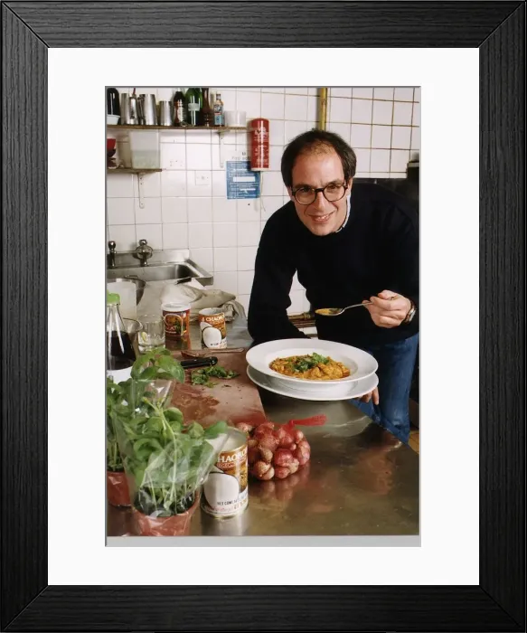 Framed Print : Loyd Grossman TV Presenter of Master Chef in his wn kitchen trying out his own cooking
