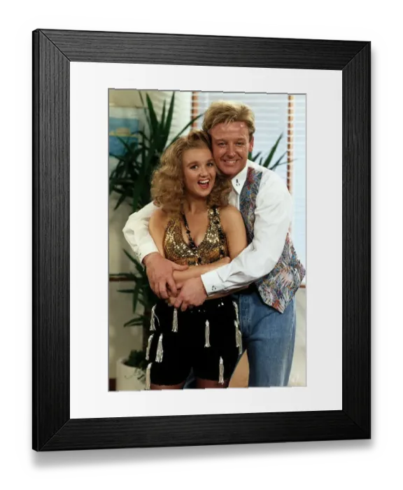Framed Print : Les Dennis Comedian and TV presenter wraps his arms around Comediene LIsa Maxwell