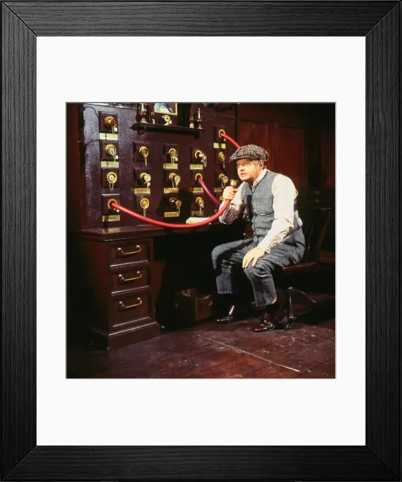 Framed Print : Benny Hill comedian November 1985 Sitting speaking into hose machine wearing cap Framed Print : Benny Hill comedian November 1985 Sitting speaking into hose machine wearing cap