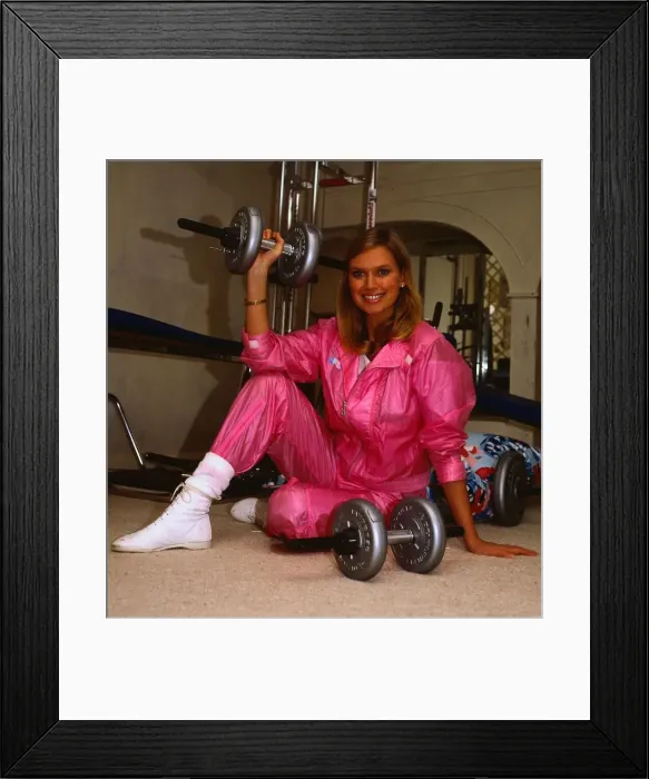 Framed Print : TV presenter Anneka Rice February 1986 sitting on floor holding weights wearing