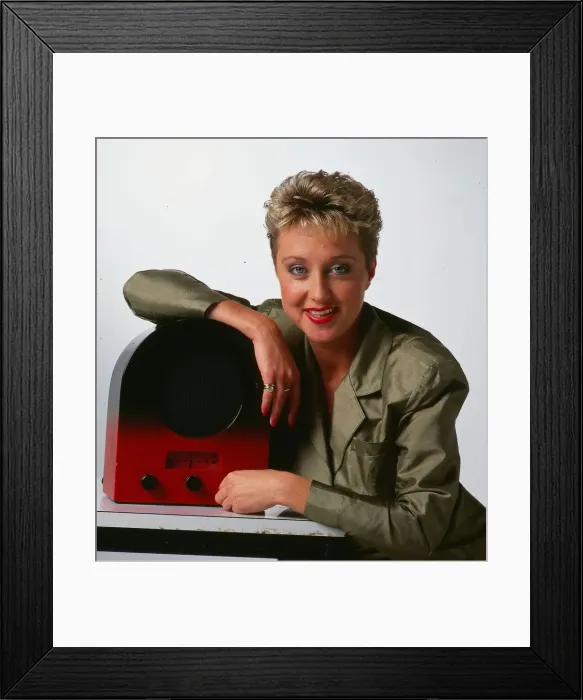 Framed Print : Cathy McDonald television presenter September 1989 leaning on an old radio wireless